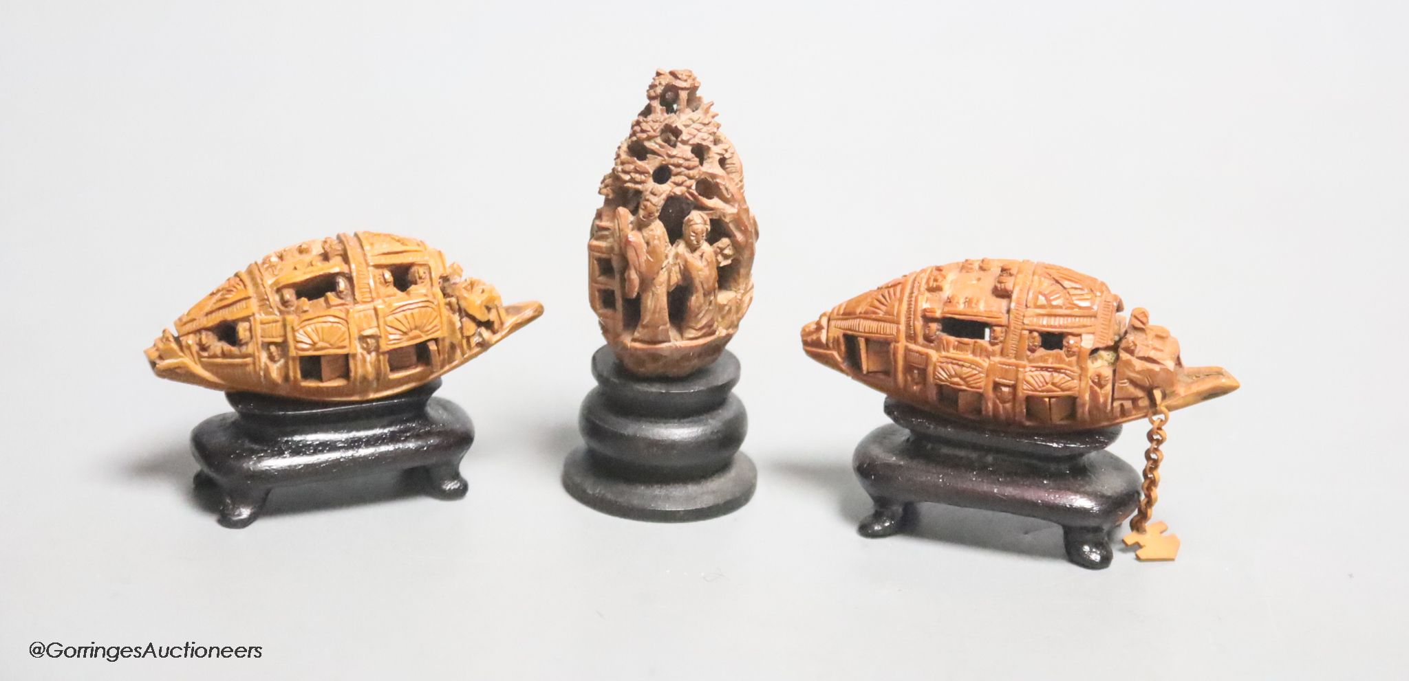 Three Chinese peach stone carvings on stands